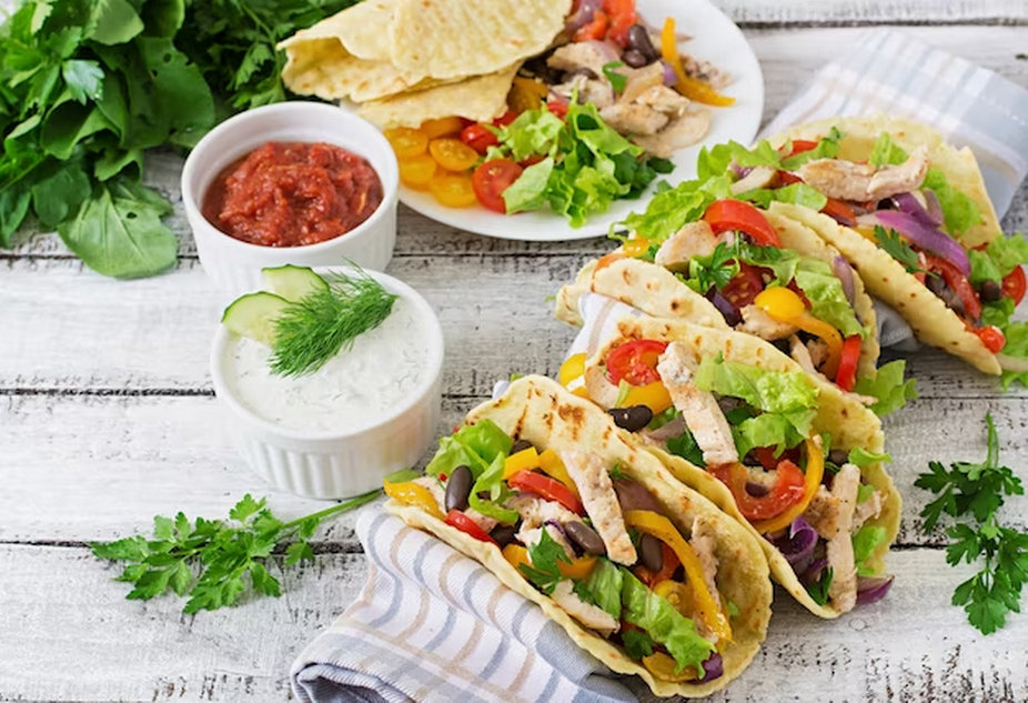 tacos with chicken, bell peppers, black beans and fresh vegetables