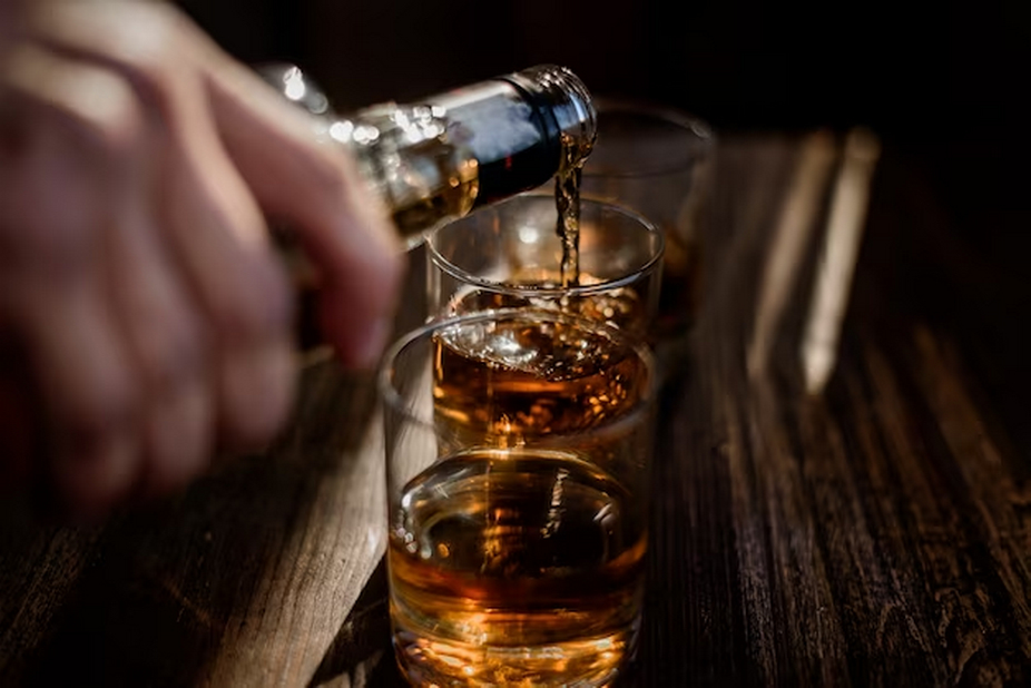 Whiskey Bottle Pouring into Glass