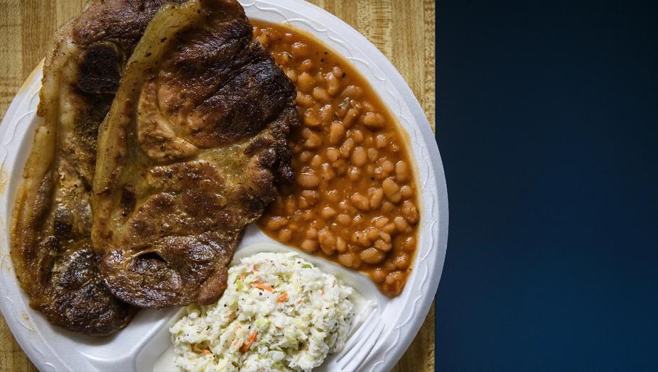 Meat, side dish and salad on a plate, top view