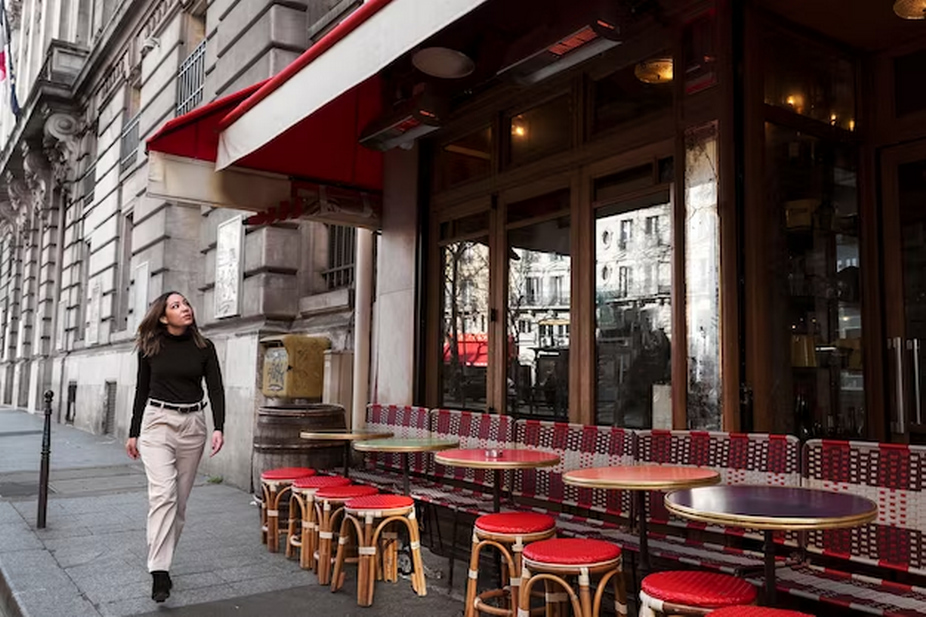 A girl passing by a restaurant