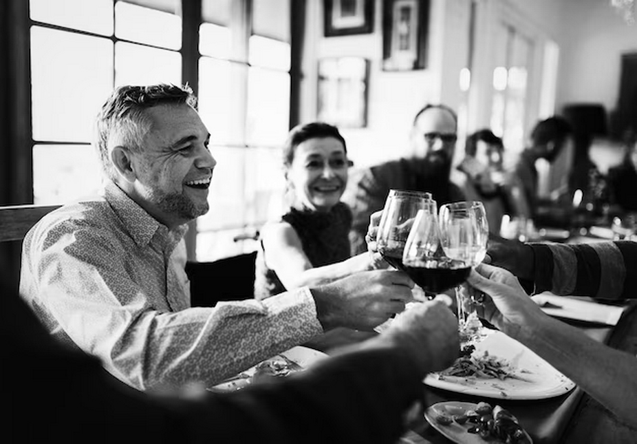 Group of people celebrating and drinking wine